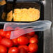 a tray of tomatoes and plastic bags