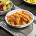 An American Metalcraft white melamine bowl filled with pasta and fruit.