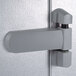The right hinged door handle on a grey door.