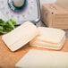 Sliced Great Lakes Mozzarella cheese on a cutting board.