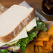 A sandwich with Great Lakes mozzarella cheese slices on a plate.