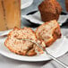 A plate with a Bake'n Joy cinnamon coffee muffin and a fork.