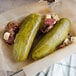 A Patriot Pickle Kosher Dill Whole Pickle on a plate with meat and cheese.