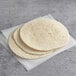 A stack of Father Sam's Bakery flour tortillas on a table.