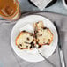 A slice of Bake'n Joy chocolate chip muffin on a plate with a fork.