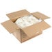 A cardboard box filled with white plastic bags of CHEEMO Three Cheese Pierogies.