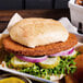 Golden breaded veal patty on a sandwich with fries.