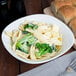 A bowl of Little Barn extra wide egg noodles with broccoli.