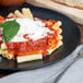 A plate of Napoli Ziti Pasta with sauce and cheese.