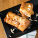 Two Orange Bakery almond bear claws on a plate.