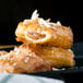 An Orange Bakery almond bear claw pastry on a plate.