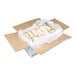 A case of ready-to-bake almond bear claw pastries individually arranged in a lined cardboard box.