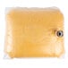 A plastic bag in a box filled with yellow liquid.