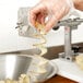 A person holding a spiral potato chip made with a Nemco Straight Chip Twister Cutter.