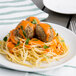 A plate of pasta with Casa Di Bertacchi Italian style beef meatballs and sauce.