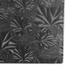 A black fabric covered in white leaves with a black and white pattern.