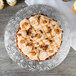 A cake with frosting and pecans on a silver Enjay cake drum.