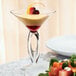 A Libbey martini glass filled with a dessert on a white plate.