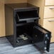 A black FireKing depository security safe with a drawer open and money inside.