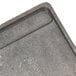 A 21" x 11" reversible cast iron griddle and grill pan with handles on a table.