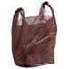 A brown plastic t-shirt bag with plastic bags inside.