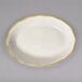 A white CAC china platter with a scalloped edge and gold trim.