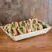 A GET Olympia melamine tray of sandwiches on a table.