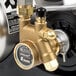 A McCann's Big Mac Fastflow carbonator machine with a brass water pump.