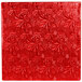 A white square cake drum with a red surface and floral designs.