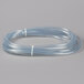 A close-up of a clear plastic hose with a white plastic tube attached.