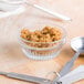 A bowl of Golden Barrel light brown sugar next to measuring spoons.