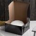 A black box with a white round object inside.