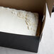 A black Enjay 1/4 sheet cake box with a cake inside.