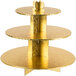 A gold three tiered cupcake stand on a table in a bakery display.