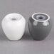 Two white porcelain salt and pepper shakers with grey lids.