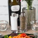 A plate of vegetables with American Metalcraft Vintage Collection salt and pepper shakers on the table.