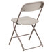 A beige plastic folding chair.