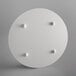 A white round object with four pegs.