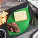 American Metalcraft Leaf Cheese Paper on a cheese plate with crackers and blueberries.