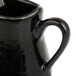 An American Metalcraft black porcelain bell creamer with a handle.