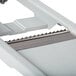 A Matfer Bourgeat composite mandoline with interchangeable blades slicing on a white surface.