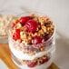A glass of granola with yogurt and 40 lb. IQF frozen pitted red tart cherries.