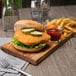A chicken sandwich with a pickle and a side of fries.