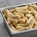 A tray of Fry Foods Breaded Mozzarella Cheese Sticks on a table.