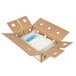 A cardboard box with two packages of Montchevre crumbled goat cheese inside.