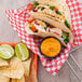 A basket of shrimp tacos with Hellmann's Ancho Chipotle sauce on the table.