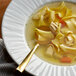 A bowl of chicken noodle soup with Knorr Chicken Base and a spoon.