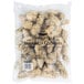 A white Boudreaux's bag filled with breaded oysters.