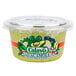 A plastic Calavo container of guacamole with a lid.
