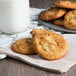 A plate of David's Cookies peanut butter cookies with a glass of milk.